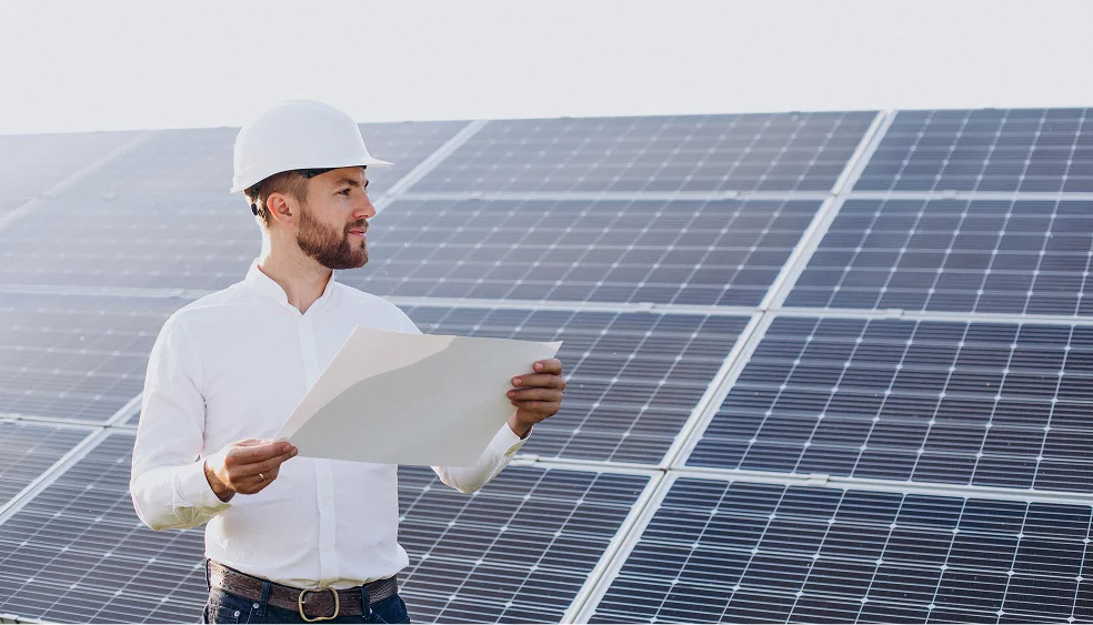 technician in front of solar panels